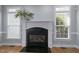 Close up of a fireplace with white mantel and two windows on either side at 815 Carpenter Town Ln, Cary, NC 27519