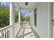 Charming front porch with white columns and railing, offering a relaxing outdoor space at 815 Carpenter Town Ln, Cary, NC 27519
