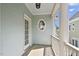 Cozy front porch featuring an oval window and white railing for a welcoming entrance at 815 Carpenter Town Ln, Cary, NC 27519