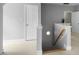 Hallway with white trim, gray walls, carpet flooring, and a staircase at 815 Carpenter Town Ln, Cary, NC 27519