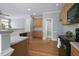 Bright kitchen features wood floors, cabinets, pantry, and appliances, creating a functional space at 815 Carpenter Town Ln, Cary, NC 27519