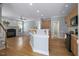 Kitchen and living room featuring open floor plan and wood floors, creating a cohesive living space at 815 Carpenter Town Ln, Cary, NC 27519
