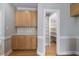 Kitchen area showcases wooden cabinets, countertop, and a pantry with shelves for ample storage at 815 Carpenter Town Ln, Cary, NC 27519