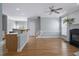 Bright living room featuring hardwood floors, fireplace, ceiling fan, and staircase at 815 Carpenter Town Ln, Cary, NC 27519