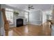 Bright living room featuring hardwood floors, fireplace, staircase, and kitchen bar at 815 Carpenter Town Ln, Cary, NC 27519
