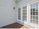 Back patio with French doors and a small deck, perfect for enjoying the outdoors at 815 Carpenter Town Ln, Cary, NC 27519