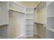 A bright walk-in closet with white shelving and rods providing ample storage space at 815 Carpenter Town Ln, Cary, NC 27519