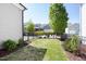 Nicely landscaped backyard featuring green lawn, a black fence, and a tidy mulch bed at 92 Cardinal Ridge Rd, Chapel Hill, NC 27516