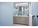A charming bathroom features a vanity with gray cabinets, bright hardware and a framed mirror at 92 Cardinal Ridge Rd, Chapel Hill, NC 27516
