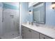 A charming bathroom features a glass shower and vanity with gray cabinets and bright hardware at 92 Cardinal Ridge Rd, Chapel Hill, NC 27516