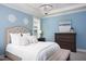 Light blue bedroom featuring an upholstered bed frame and a decorative crystal chandelier at 92 Cardinal Ridge Rd, Chapel Hill, NC 27516