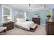 Light blue bedroom featuring an upholstered bed frame and a decorative crystal chandelier at 92 Cardinal Ridge Rd, Chapel Hill, NC 27516