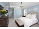 Light blue bedroom featuring an upholstered bed frame and a decorative crystal chandelier at 92 Cardinal Ridge Rd, Chapel Hill, NC 27516