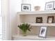 Built-in shelves featuring decor and Gathering photos near a window at 92 Cardinal Ridge Rd, Chapel Hill, NC 27516