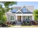 Charming home exterior featuring a covered porch, stone accents, and well-maintained landscaping at 92 Cardinal Ridge Rd, Chapel Hill, NC 27516