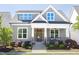 Inviting home exterior with a cozy front porch, decorative columns, and manicured garden at 92 Cardinal Ridge Rd, Chapel Hill, NC 27516