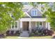 Charming home with a welcoming front porch, stone steps, and attractive landscaping at 92 Cardinal Ridge Rd, Chapel Hill, NC 27516