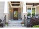 Covered front porch featuring a wooden ceiling, classic sconces, and comfortable seating at 92 Cardinal Ridge Rd, Chapel Hill, NC 27516