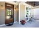 Close up of a covered front porch showcasing a glass door and comfortable seating area at 92 Cardinal Ridge Rd, Chapel Hill, NC 27516
