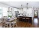 Bright, eat-in kitchen with white cabinetry, stainless appliances, and hardwood floors at 92 Cardinal Ridge Rd, Chapel Hill, NC 27516