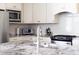 Modern kitchen featuring stainless steel appliances, granite countertops, and white cabinetry at 92 Cardinal Ridge Rd, Chapel Hill, NC 27516