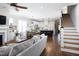 Open concept living room flowing into a modern kitchen with a breakfast bar and staircase at 92 Cardinal Ridge Rd, Chapel Hill, NC 27516