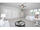 Bright bedroom with natural light, neutral tones, ceiling fan, and sitting area at 92 Cardinal Ridge Rd, Chapel Hill, NC 27516