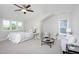 Bright main bedroom featuring neutral tones, a ceiling fan, and comfortable seating area at 92 Cardinal Ridge Rd, Chapel Hill, NC 27516