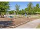 Community playground with swings, a seesaw, and a basketball court at 92 Cardinal Ridge Rd, Chapel Hill, NC 27516
