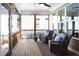 Charming screened-in porch with cozy blue chairs, ceiling fan, outdoor string lights, and a decorative rug at 92 Cardinal Ridge Rd, Chapel Hill, NC 27516