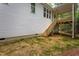 A partially finished backyard with a view of a raised wooden deck and surrounding wooded area at Lot 3260 Yorkshire Cir, Sanford, NC 27332
