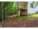 A partially finished backyard with a view of a raised wooden deck and surrounding wooded area at Lot 3260 Yorkshire Cir, Sanford, NC 27332
