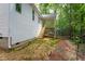 A partially finished backyard with a view of a raised wooden deck and surrounding wooded area at Lot 3260 Yorkshire Cir, Sanford, NC 27332