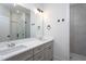 Modern bathroom featuring a double sink vanity and a tiled shower with glass doors at Lot 3260 Yorkshire Cir, Sanford, NC 27332