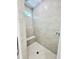Walk-in shower featuring a built-in bench, a tiled interior, and a window for natural light at Lot 3260 Yorkshire Cir, Sanford, NC 27332