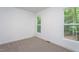 Bright bedroom featuring carpet, white walls, and a window with view of mature trees at Lot 3260 Yorkshire Cir, Sanford, NC 27332