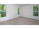 Bright bedroom features plush carpet, fresh paint, and windows with wooded views at Lot 3260 Yorkshire Cir, Sanford, NC 27332