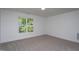 A bright bedroom with a view and neutral carpet at Lot 3260 Yorkshire Cir, Sanford, NC 27332