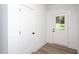 Bright entryway featuring a white door with glass panes, leading to the outside and wood-look flooring at Lot 3260 Yorkshire Cir, Sanford, NC 27332