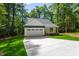 Charming single-story home with attached garage, manicured lawn and long driveway in a wooded community at Lot 3260 Yorkshire Cir, Sanford, NC 27332