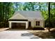 Inviting single-story home with attached garage, brick-lined entry steps, and a well-maintained lawn surrounded by trees at Lot 3260 Yorkshire Cir, Sanford, NC 27332