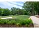 Picturesque golf course featuring lush fairways, sand traps, mature trees, and a paved walking path at Lot 3260 Yorkshire Cir, Sanford, NC 27332