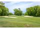 Expansive golf course featuring lush green fairways, sand traps, and tree-lined perimeter under a bright sky at Lot 3260 Yorkshire Cir, Sanford, NC 27332