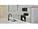 Modern kitchen featuring white cabinets, stainless steel appliances, tile backsplash, and a quartz countertop at Lot 3260 Yorkshire Cir, Sanford, NC 27332