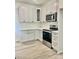 Modern kitchen featuring white cabinets, stainless steel appliances, and a stylish subway tile backsplash at Lot 3260 Yorkshire Cir, Sanford, NC 27332
