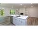 Gourmet kitchen island featuring built-in stainless steel dishwasher and view of the fireplace and living room at Lot 3260 Yorkshire Cir, Sanford, NC 27332