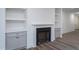 A modern fireplace with built in cabinets and shelving and wood flooring at Lot 3260 Yorkshire Cir, Sanford, NC 27332