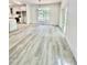 Spacious living area with light gray flooring, modern light fixture, and sliding glass doors at Lot 3260 Yorkshire Cir, Sanford, NC 27332