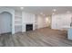 A modern living room with built in shelving and cabinets surrounding a fireplace at Lot 3260 Yorkshire Cir, Sanford, NC 27332