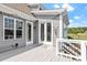 Back deck area featuring glass doors, string lights, and a welcoming outdoor ambiance at 10 Princeton Manor Dr, Youngsville, NC 27596